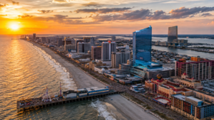 Atlantic City skyline at sunset featuring Ocean Casino Resort, Steel Pier, the Boardwalk, and some of the city's best casino resorts