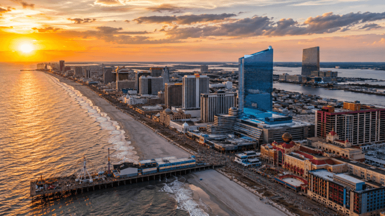 Atlantic City skyline at sunset featuring Ocean Casino Resort, Steel Pier, the Boardwalk, and some of the city's best casino resorts