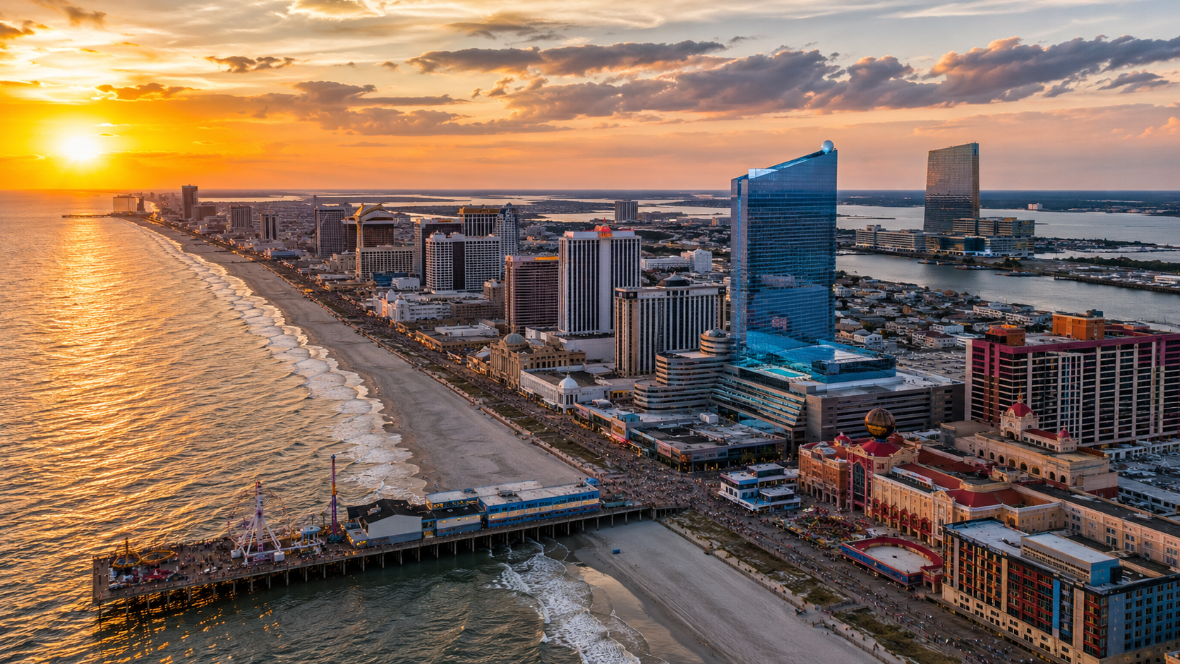 Atlantic City skyline at sunset featuring Ocean Casino Resort, Steel Pier, the Boardwalk, and some of the city's best casino resorts