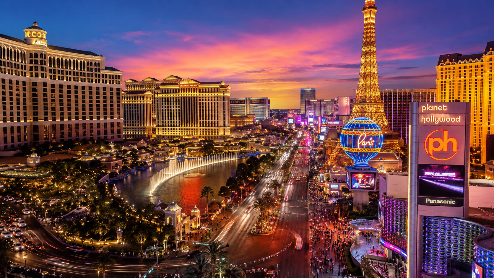Las Vegas Strip at sunset with illuminated hotels and crowds of visitors