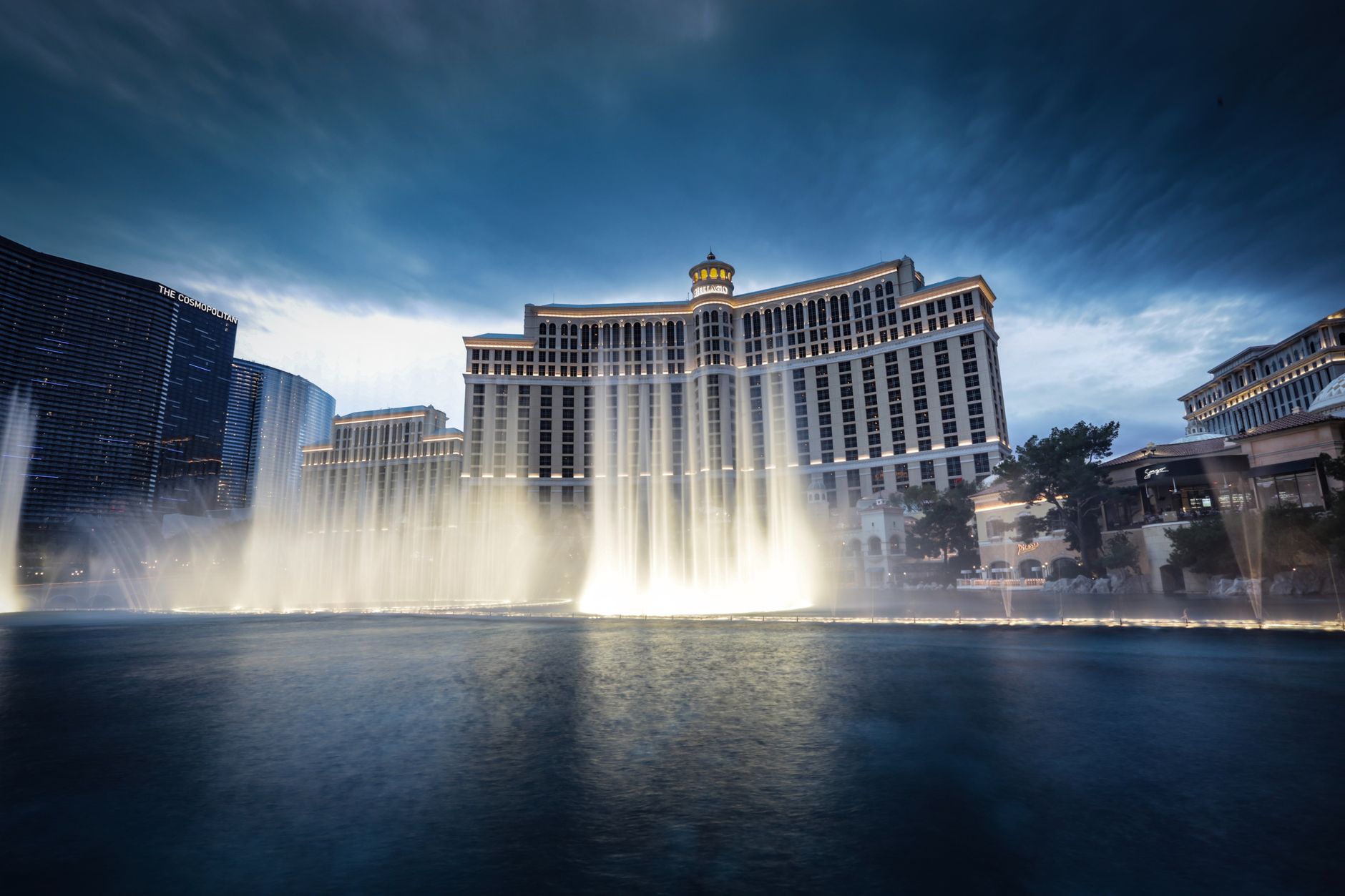 Bellagio Fountain and Las Vegas skyline at twilight